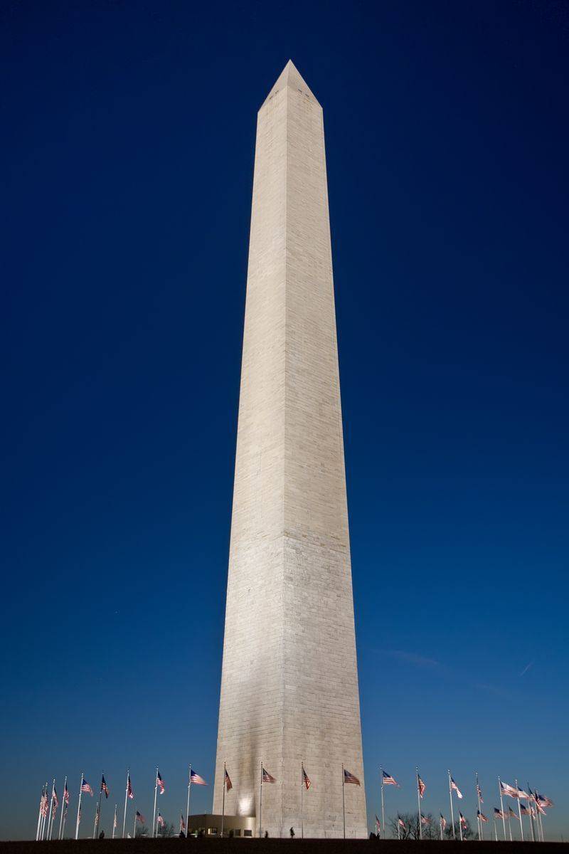 The Washington Monument rising over the National Mall with the ring of state flags