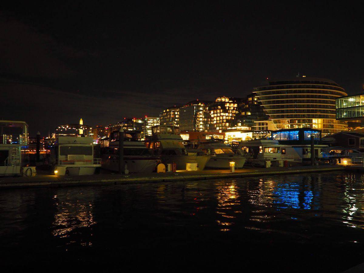 The Wharf marina and waterfront buildings lit up at night